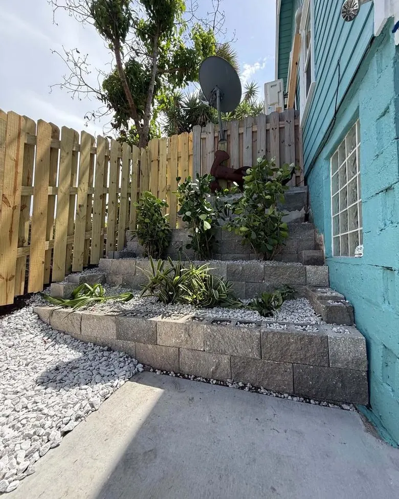 Side yard after: rebuilt tiered retaining wall and plantings